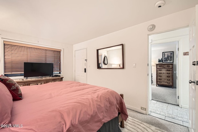 bedroom featuring carpet floors and baseboards