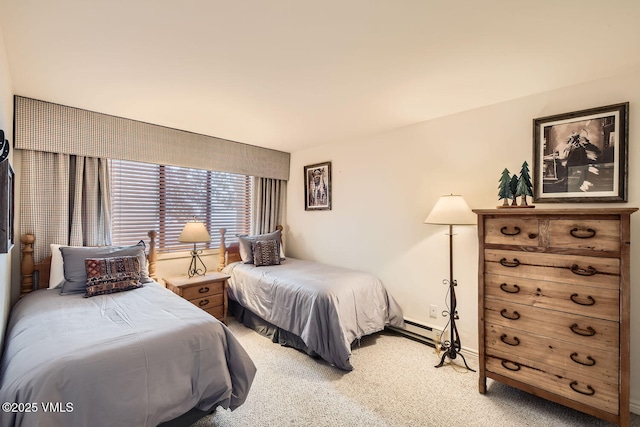 bedroom with a baseboard heating unit, carpet, and baseboards