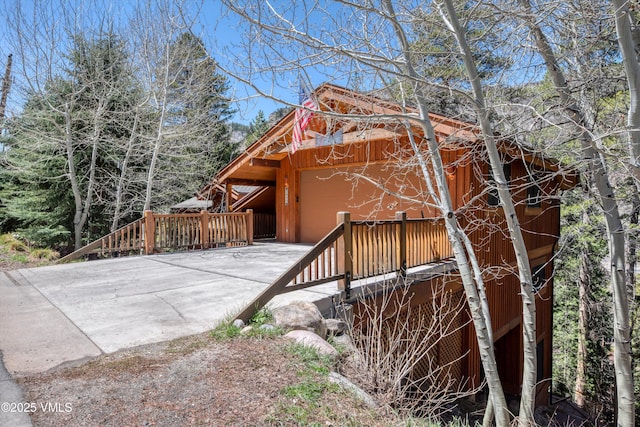 view of property exterior with an attached garage and driveway