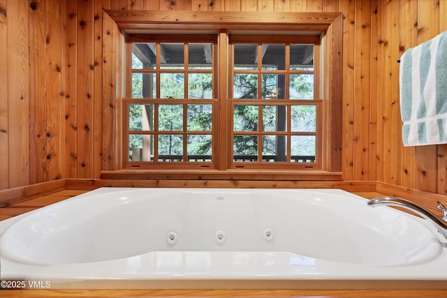 full bath featuring wooden walls and a whirlpool tub