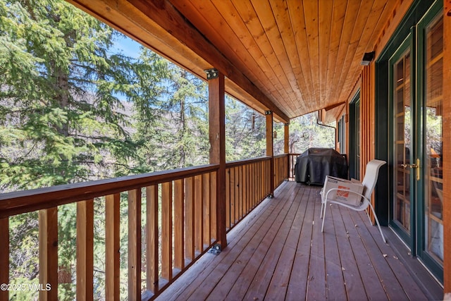 wooden terrace with a grill