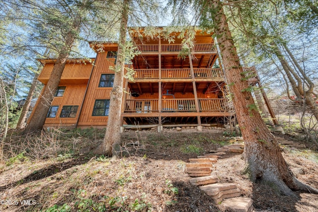 rear view of house featuring a balcony