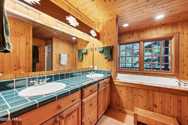 bathroom with a sink, tile patterned floors, a garden tub, and double vanity