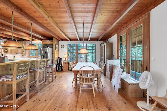 dining area featuring wood ceiling, plenty of natural light, french doors, and beam ceiling