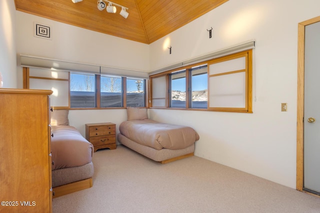 carpeted bedroom with lofted ceiling and wood ceiling