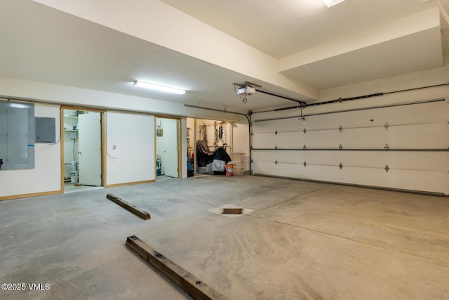 garage with a garage door opener and electric panel