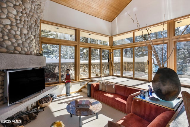 sunroom featuring vaulted ceiling and wood ceiling