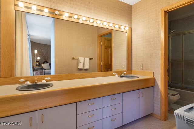 full bathroom featuring enclosed tub / shower combo, vanity, and toilet