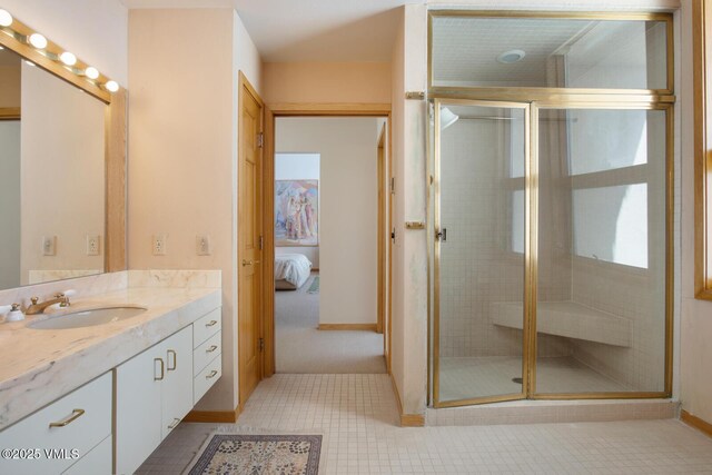 bathroom featuring vanity, tile patterned flooring, and a shower with door