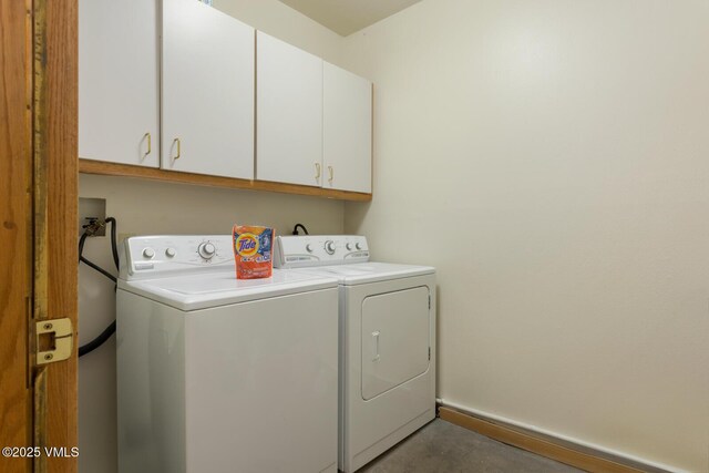 laundry area with cabinets and washing machine and dryer