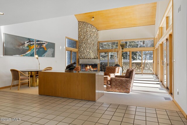 tiled living room with a fireplace, high vaulted ceiling, and wooden ceiling