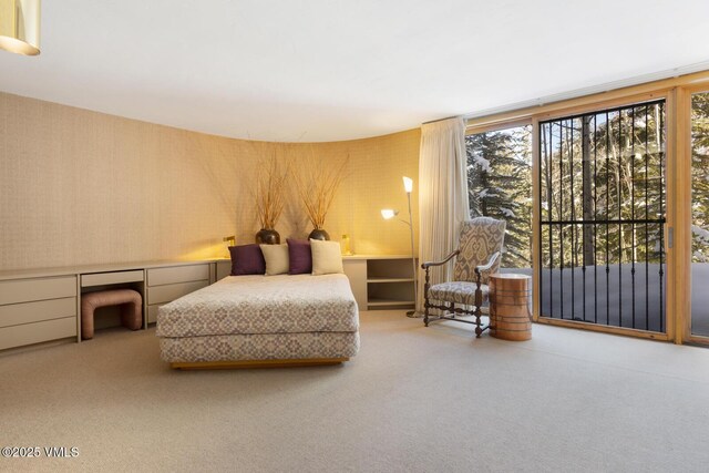 bedroom with carpet flooring and built in desk