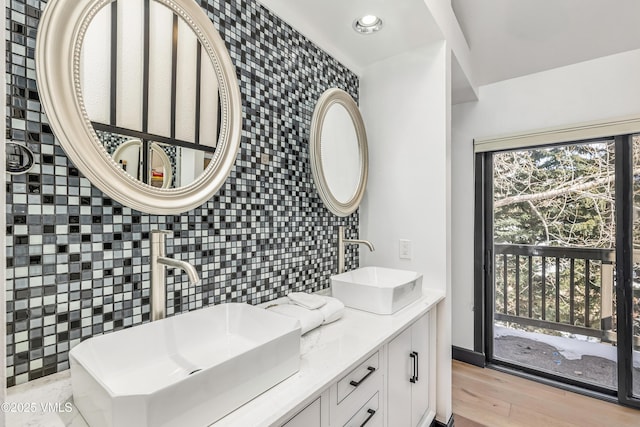 4524 Meadow Dr Unit 905, Vail, CO 81657 - bathroom with recessed lighting, tile walls, double vanity, backsplash, and wood finished floors