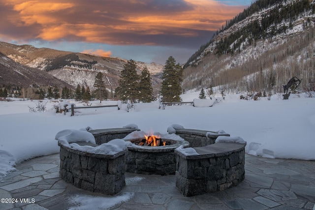 exterior space featuring a mountain view and a fire pit