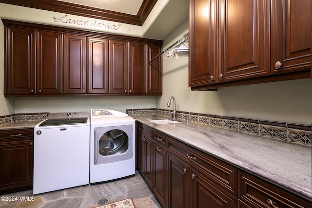 laundry area featuring cabinets, crown molding, sink, and independent washer and dryer