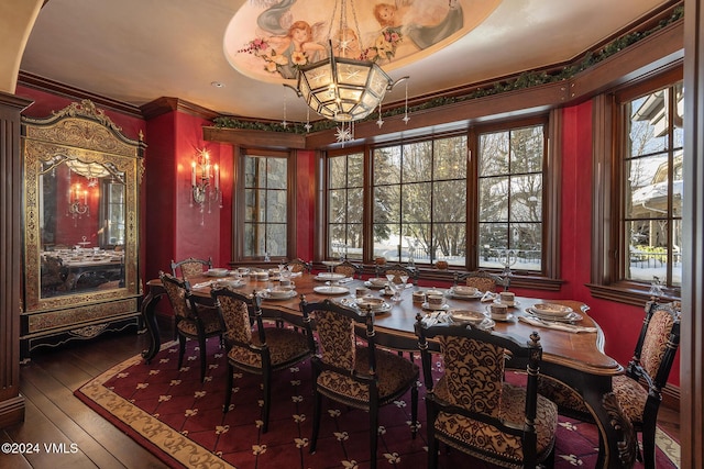 dining area featuring hardwood / wood-style floors and ornamental molding