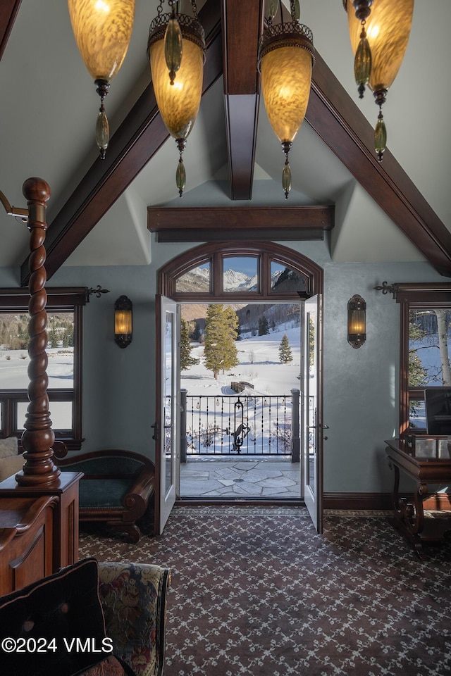 entrance foyer featuring lofted ceiling with beams and dark colored carpet