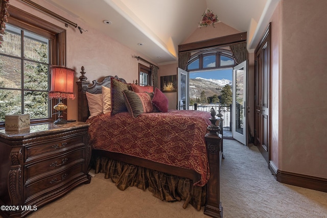 bedroom with vaulted ceiling, light carpet, access to outside, and a mountain view