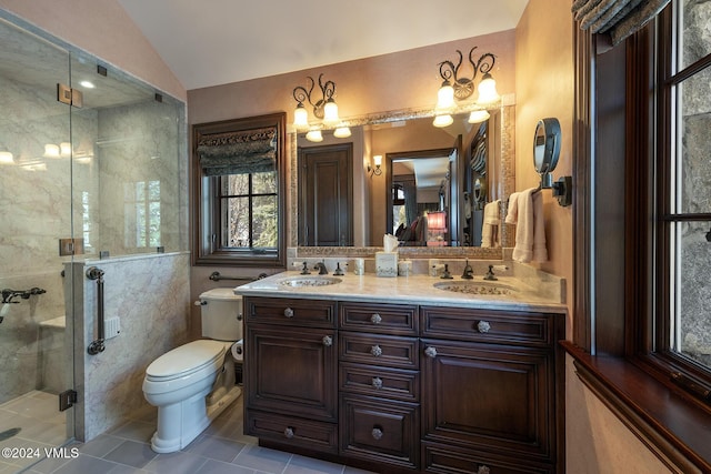 bathroom with lofted ceiling, vanity, toilet, a shower with door, and tile patterned floors