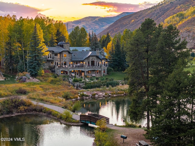 exterior space with a water and mountain view