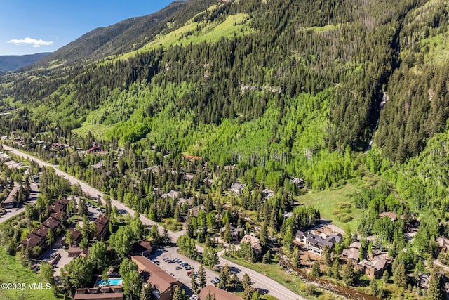 4031 Bighorn Rd Unit 9-H, Vail, CO 81657 - drone / aerial view of a heavily wooded area and a mountain backdrop