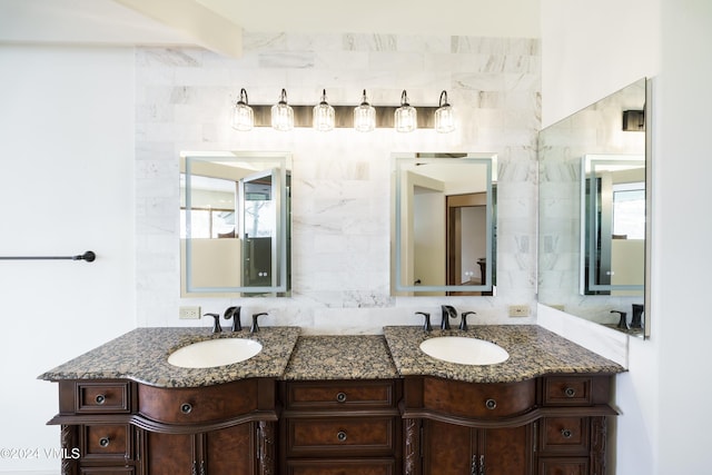 bathroom featuring a wealth of natural light, a sink, and double vanity