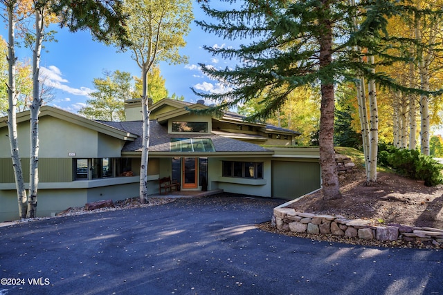 view of front of home with aphalt driveway and a chimney