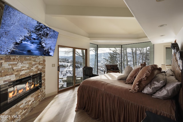 4747 Wildridge Rd, Avon, CO 81620 - bedroom with vaulted ceiling, wood finished floors, a glass covered fireplace, access to outside, and recessed lighting