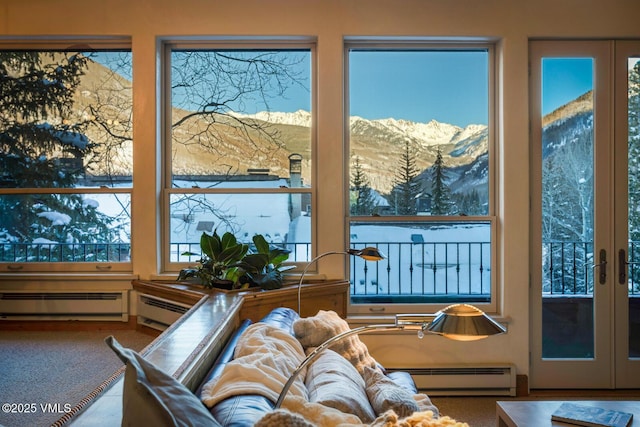 doorway featuring a mountain view, carpet, french doors, and a baseboard heating unit