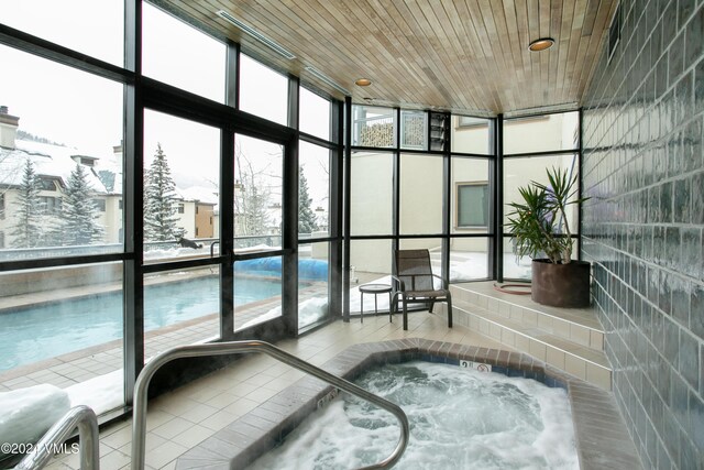 sunroom / solarium featuring wood ceiling and a jacuzzi