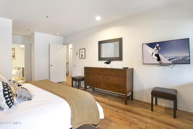 bedroom with wood-type flooring and ensuite bathroom