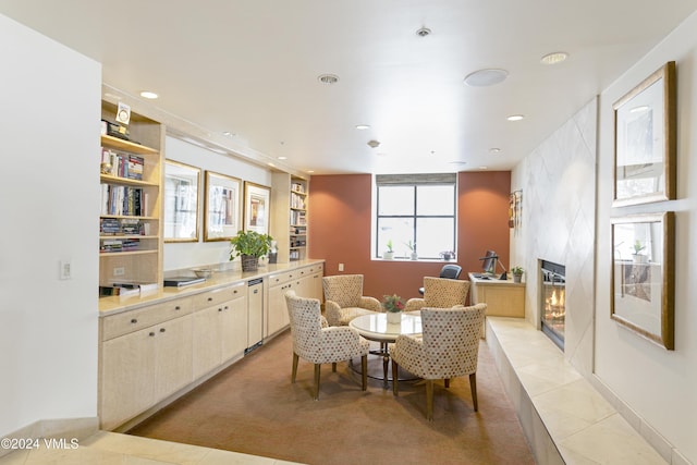 dining area featuring light tile patterned flooring and a fireplace