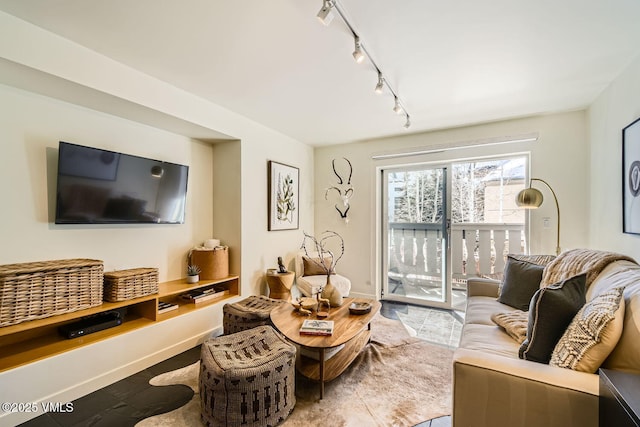 living area featuring baseboards