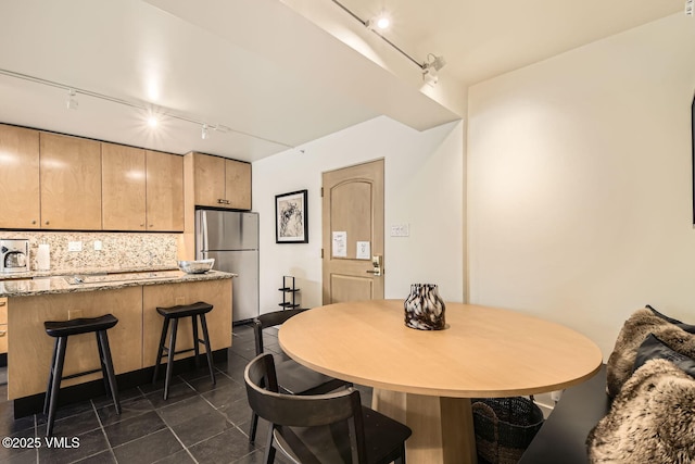 dining room with dark tile patterned flooring