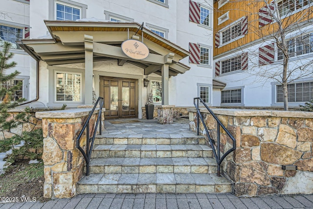 view of exterior entry featuring french doors