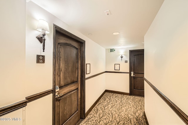 corridor with light carpet and baseboards