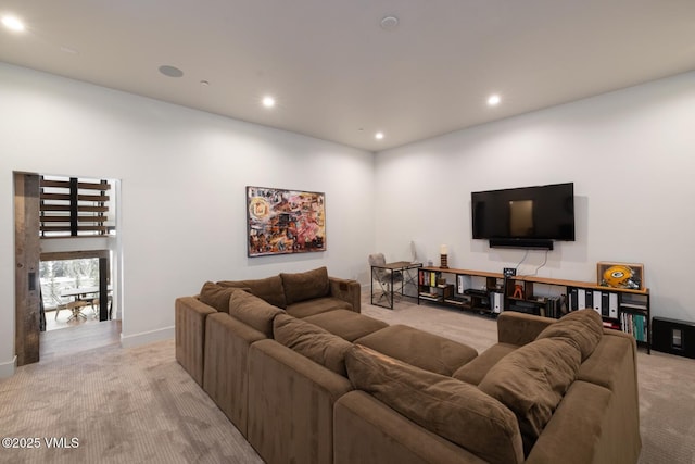 living area featuring recessed lighting, baseboards, and light carpet