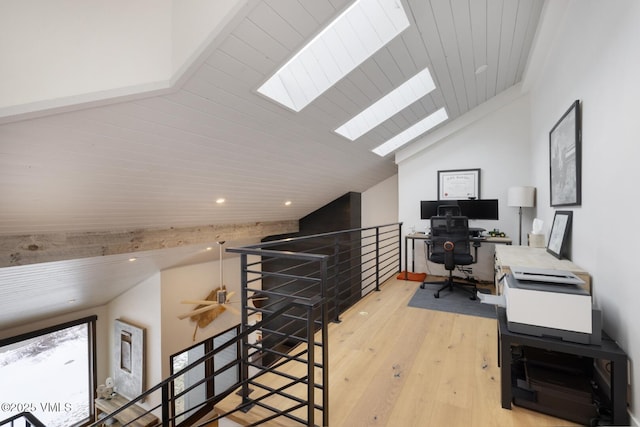 office space with recessed lighting, light wood-type flooring, vaulted ceiling with skylight, and wooden ceiling