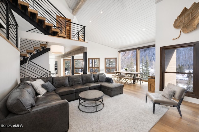 living area featuring plenty of natural light, wood finished floors, and stairs