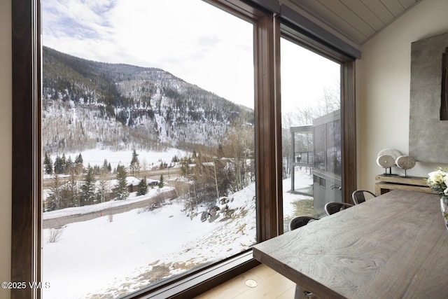 doorway to outside with vaulted ceiling and a mountain view