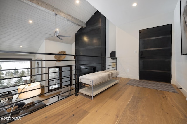 interior space featuring recessed lighting, lofted ceiling with beams, baseboards, and wood finished floors