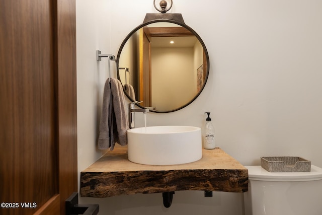 bathroom with toilet and a sink