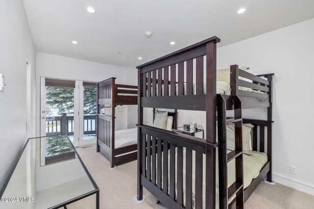 carpeted bedroom featuring recessed lighting, baseboards, and access to outside