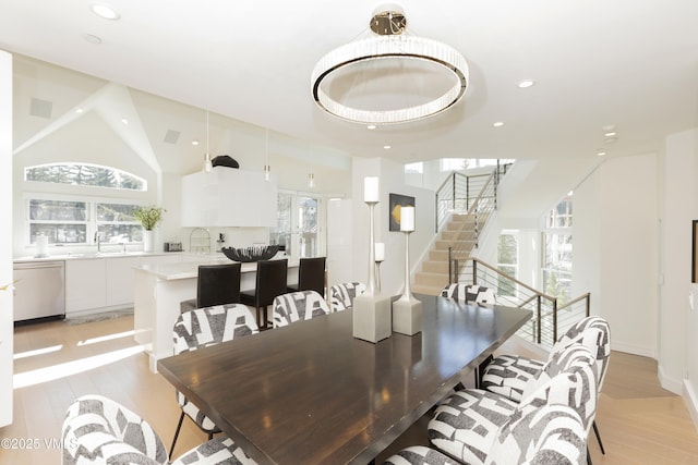 dining room with stairs, recessed lighting, and light wood finished floors