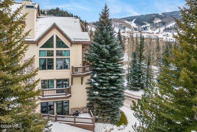 snow covered building with a mountain view