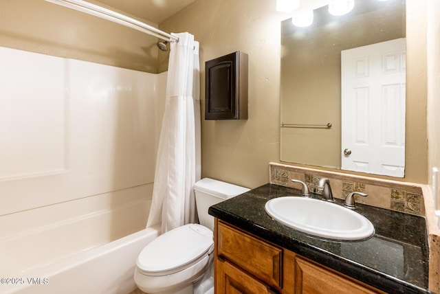 bathroom with vanity, shower / tub combo, and toilet