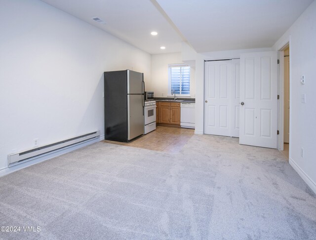 49 Bluffs Dr, Eagle, CO 81631 - kitchen with light carpet, sink, white appliances, and baseboard heating