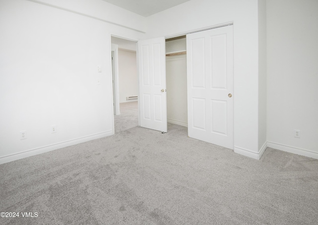 49 Bluffs Dr, Eagle, CO 81631 - unfurnished bedroom featuring light carpet, a closet, and baseboard heating