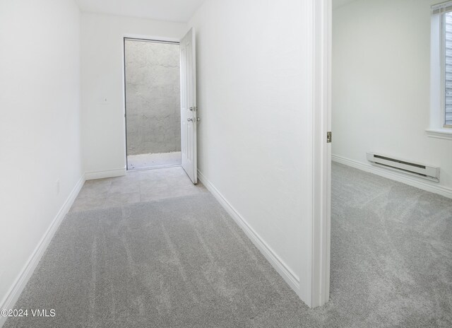 49 Bluffs Dr, Eagle, CO 81631 - hall with light colored carpet and a baseboard radiator