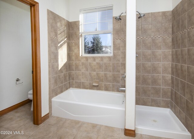 49 Bluffs Dr, Eagle, CO 81631 - bathroom featuring tile patterned flooring, shower with separate bathtub, and toilet